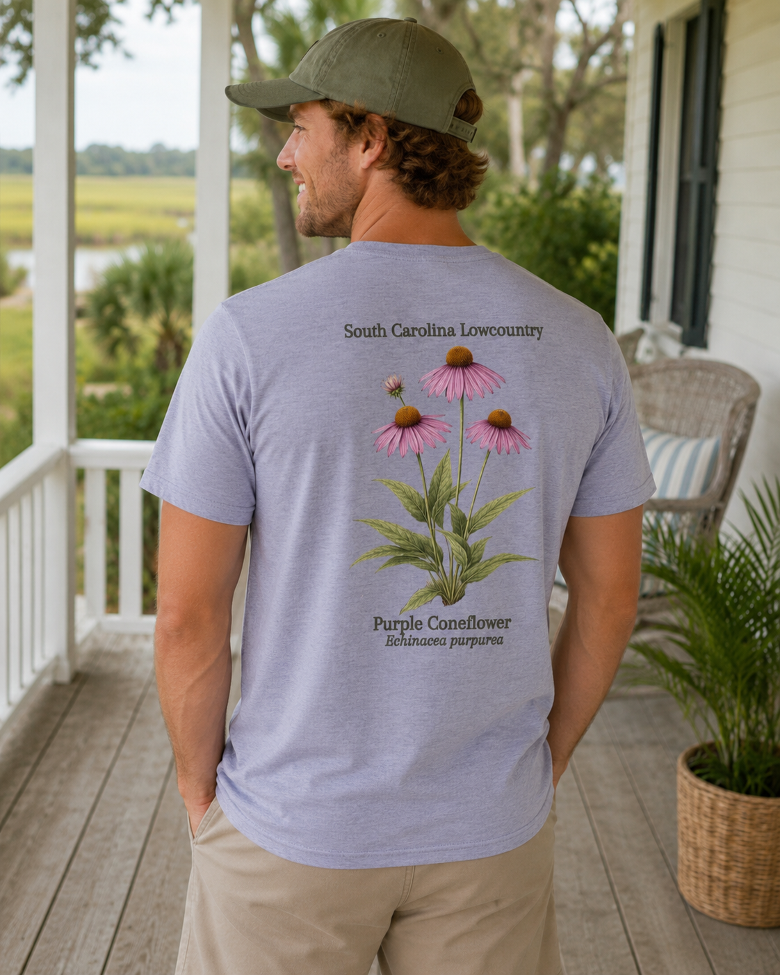 Man wearing a t-shirt with a purple coneflower design on a porch