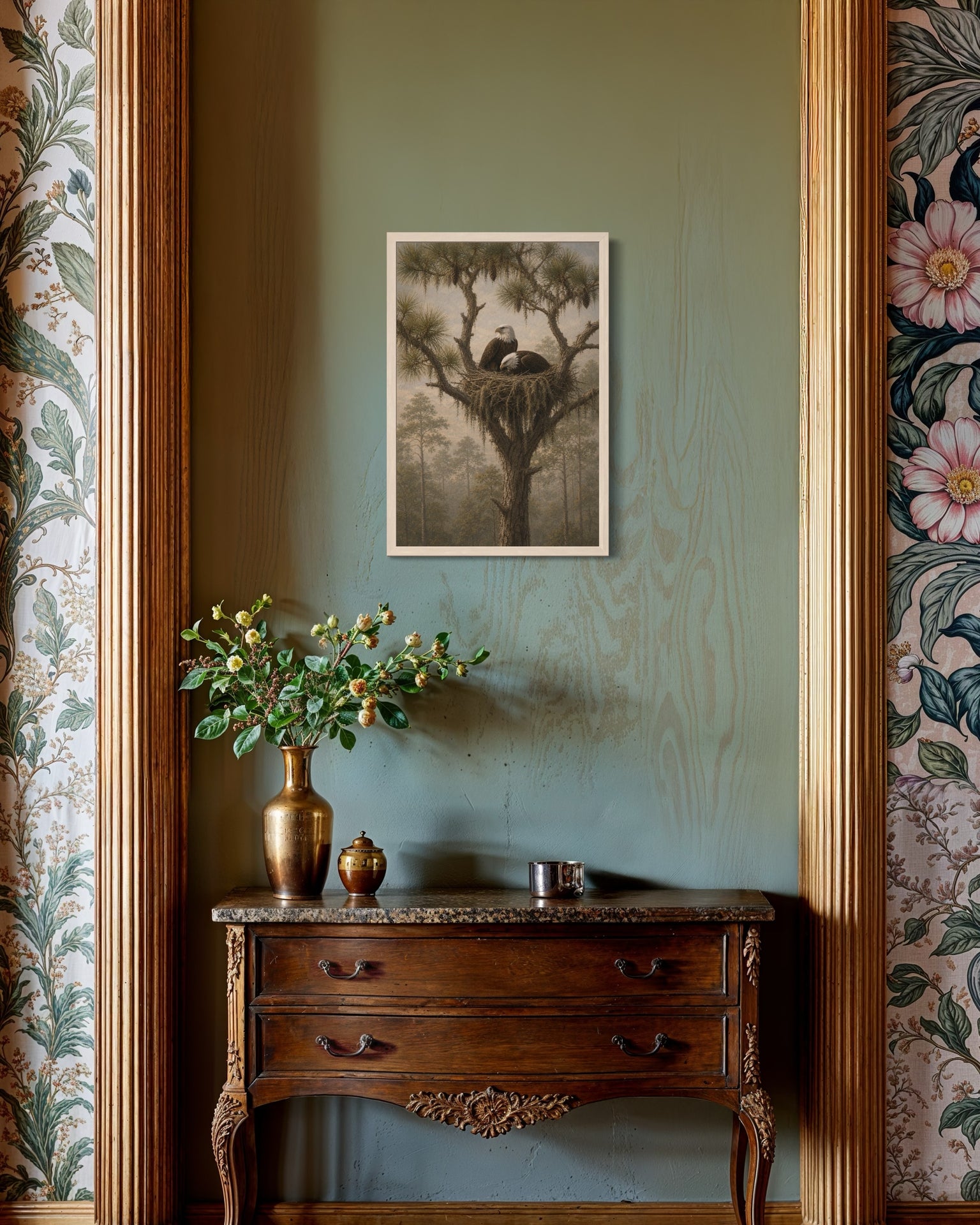 Decorative interior with a framed print, vase, and decorative items on a wooden console against a patterned wall.